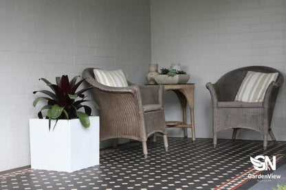Modern square cube pots in various sizes arranged on a patio with plants, showing clean geometric lines