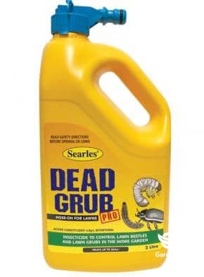 Dead Grub Pro soil treatment package on garden soil with healthy plants growing in treated area