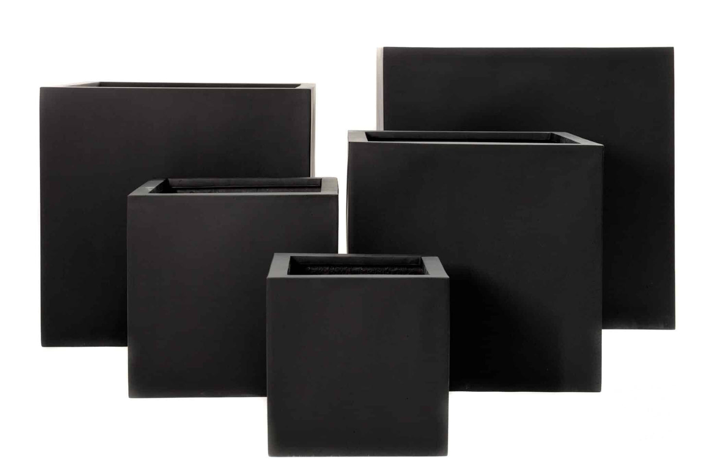 Modern square cube pots in various sizes arranged on a patio with plants, showing clean geometric lines