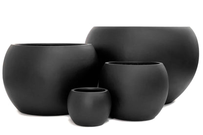 Curved dome-shaped ceramic pots in various sizes displaying different plants on a garden bench