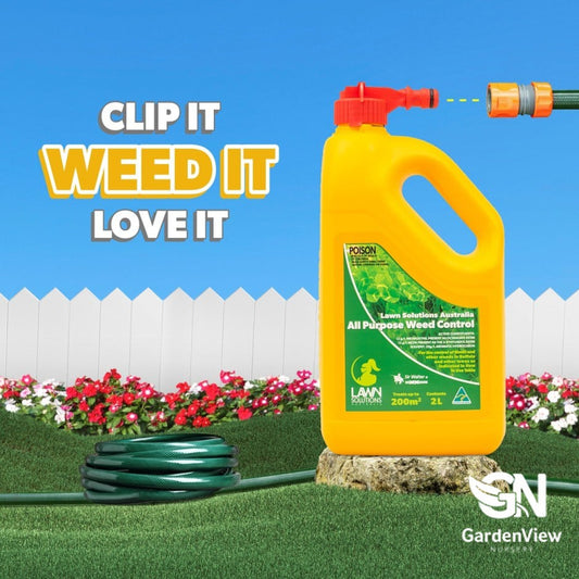 All purpose weed control spray bottle with pump action nozzle on green lawn with scattered weeds